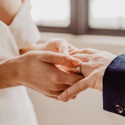 A ring being put onto a finger during the ceremony.