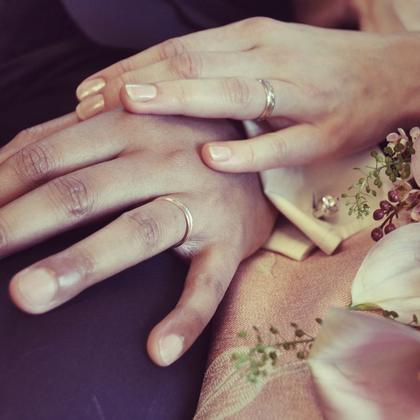 Hands resting on a bouquet.